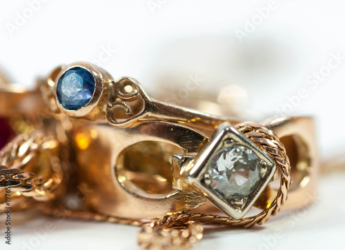 Real gold rings with blue gem , gold chain isolated on white background.