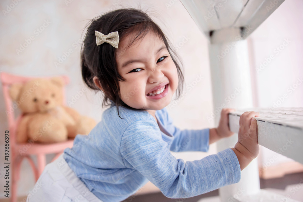Lovely Kids Portrait, a Happy 2 Years Old Child Smiling and looking at camera. Playful Little Girl Playing Hide and Seek Game Lovely Kids Portrait, a Happy 2 Years Old Child Smiling and looking at camera. Playful Little Girl Playing Hide and Seek Game