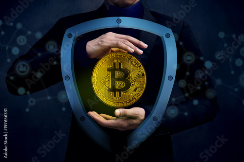 Digital Cryptocurrency Sucurity Concept. Businessman in Gesture Hand to Protect a Golden Bitcoin Money inside Shield Guard from Internet Hacking photo