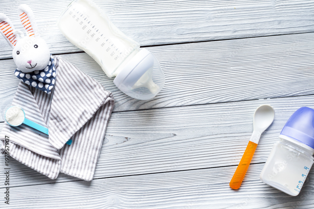 preparation of mixture baby feeding on wooden background top vie