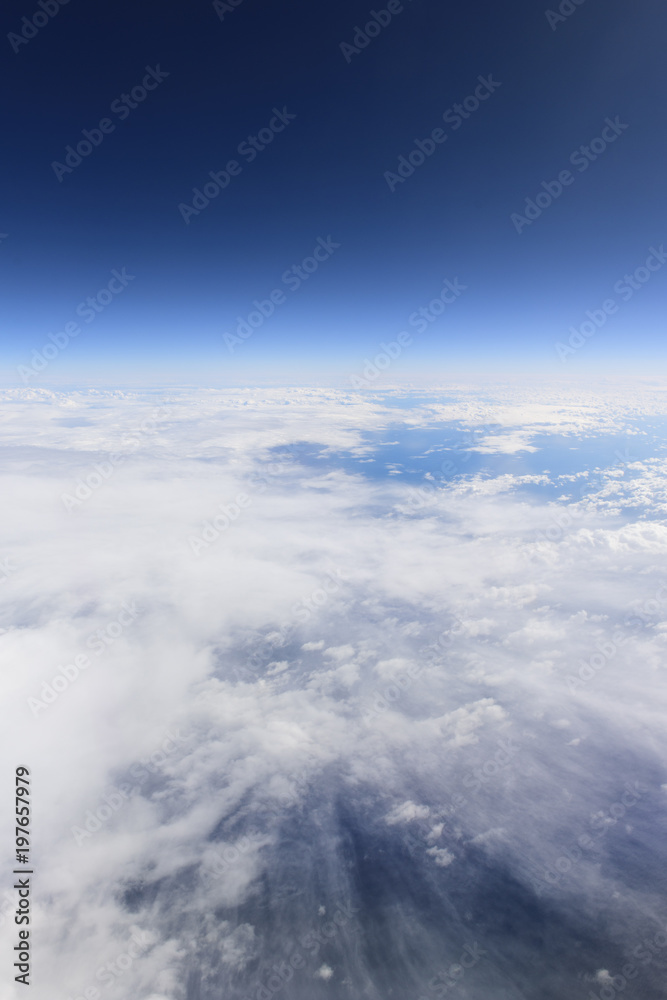 Blue sky and white clouds from window of airplane, aerial photography Blue sky and white clouds from window of airplane, aerial photography