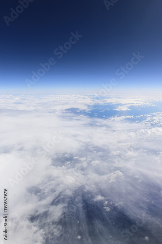 Blue sky and white clouds from window of airplane, aerial photography