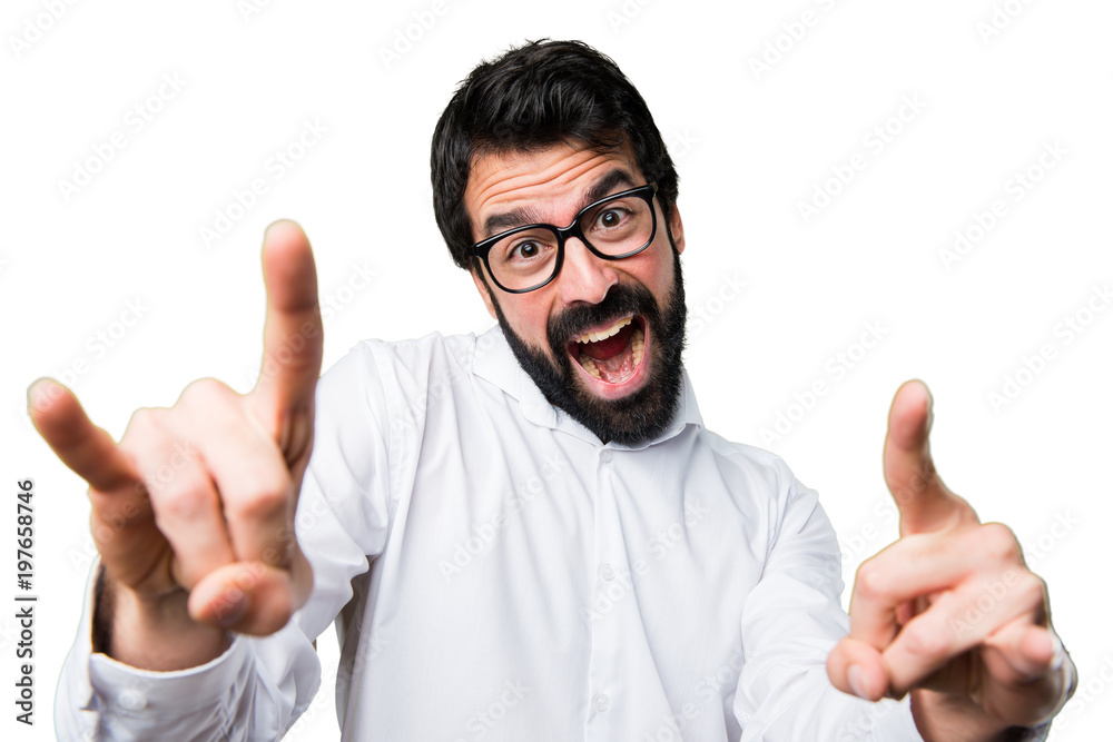Handsome man with glasses making horn gesture Handsome man with glasses making horn gesture