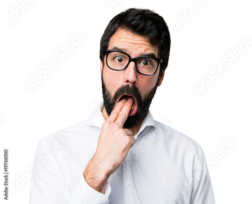 Handsome man with glasses making vomiting gesture