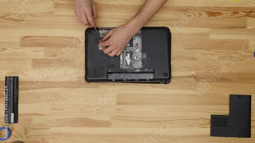 Male engineer repairs laptop