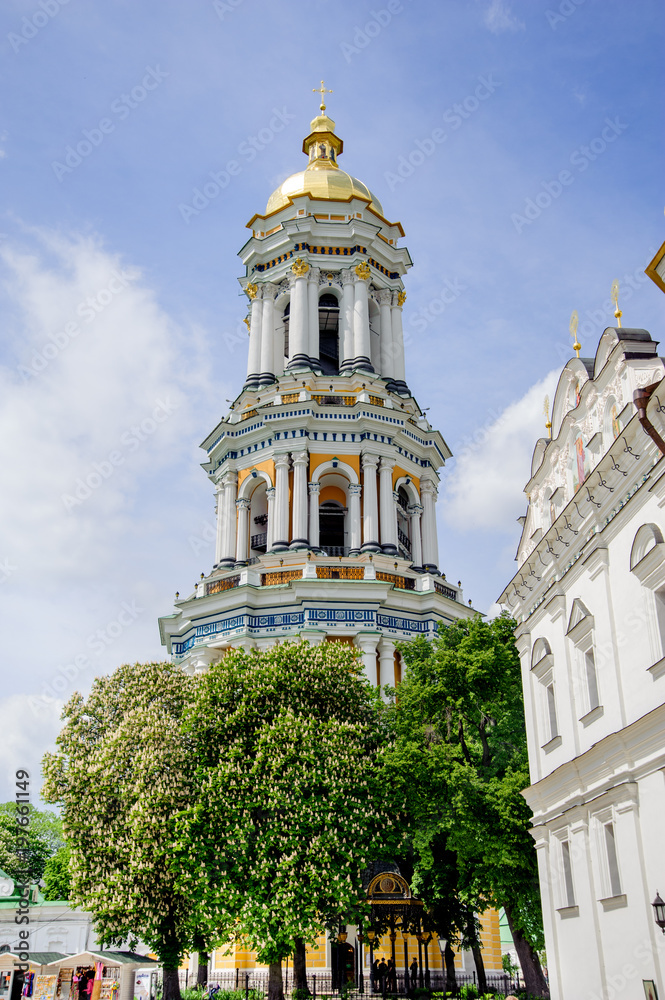 Kiev, Ukraine: Interior of the Orthodox Church, altar, iconostasis, beautiful historical architectural arches, painted icons, murals, natural light, gilding, faith, windows, light, sky, clouds