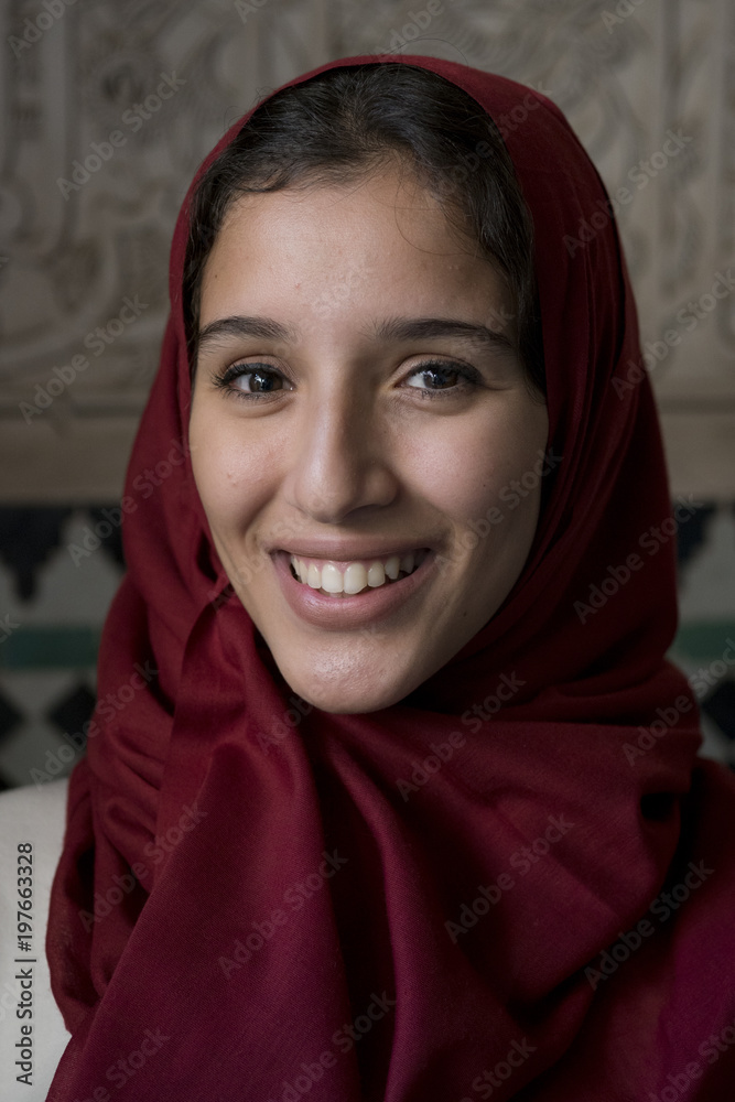Portrait of young muslim woman smiling with red hijab headscarf Portrait of young muslim woman smiling with red hijab headscarf