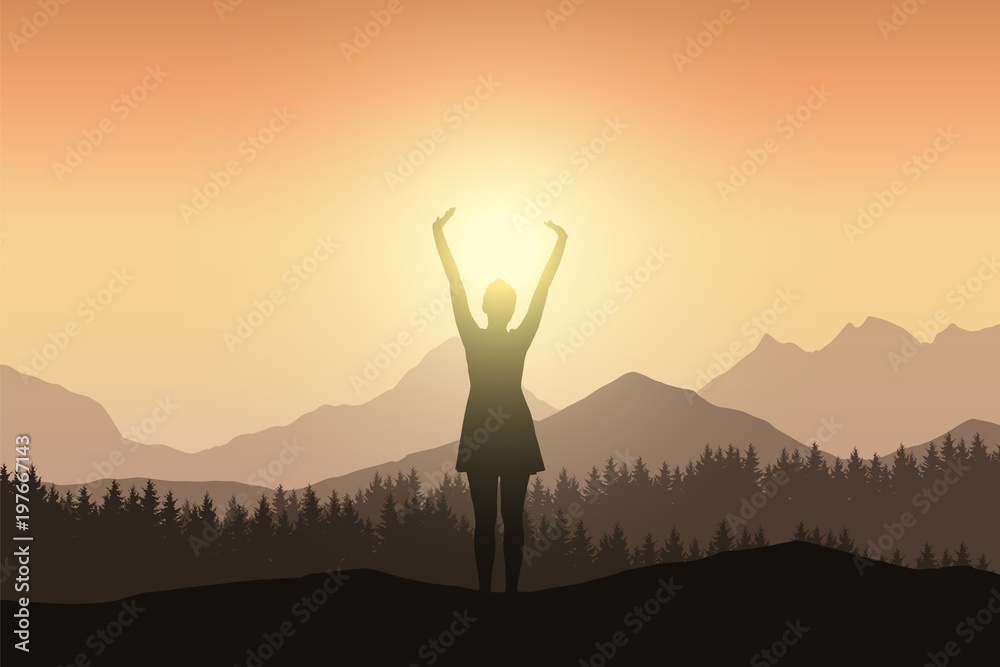 Young woman in dress with raised hands in mountain landscape with forest in sunshine
