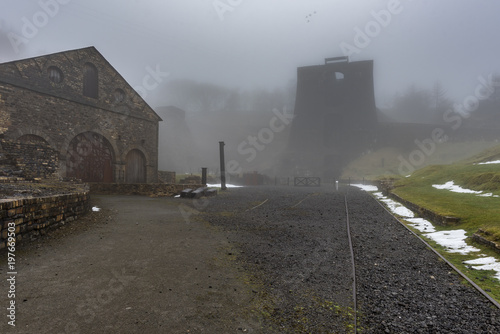 Blaenavon Ironworks, in the South Wales Valley's, with the old, industrial buildings cloaked in fog and mist photo