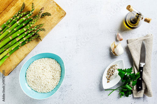 Ingredients for cooking risotto with asparagus on a table