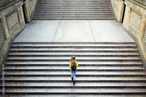 High angle view of woman climbing steps at park photo