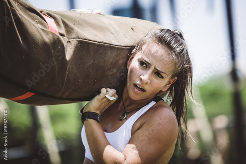 Woman carrying brute ball while standing outdoors