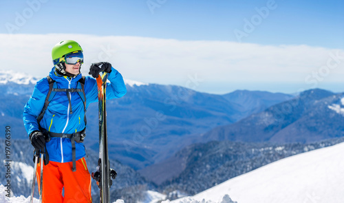 Panorama of sporty man with skis