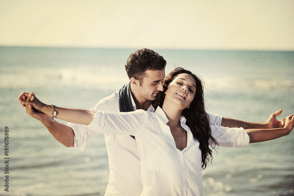 happy young couple have fun at beautiful beach happy young couple have fun at beautiful beach