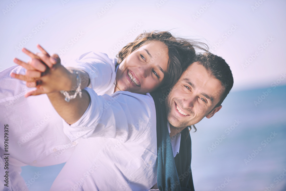 happy young couple have fun at beautiful beach happy young couple have fun at beautiful beach