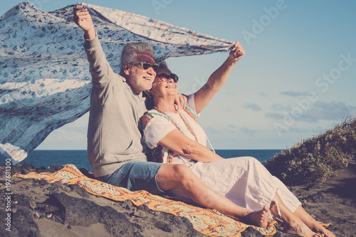 hippy aged couple at the beach photo