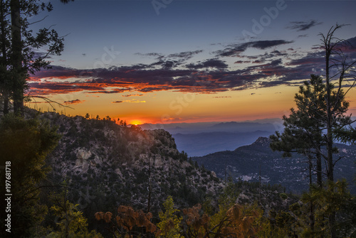 Distant mountain ranges and a setting sun visible from Mt.Lemmon, AZ.