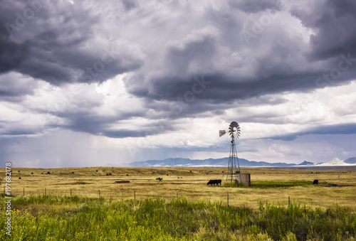 Sonoita Arizona ranch land. Windmill and rain shower visible.