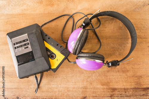 Personal stereo, cassette tape and headphones on a wooden board