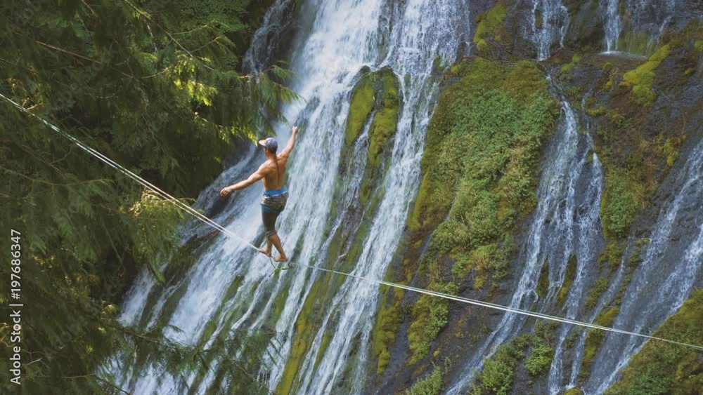 Fit Man Highlining Over A Waterfall In Oregon