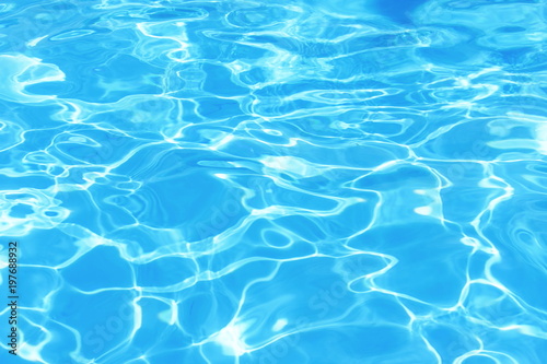 Background of clean blue rippled water in a hotel swimming pool