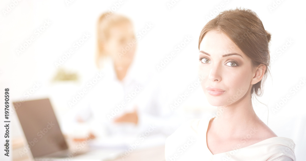 Portrait of a businesswoman sitting at desk with laptop Portrait of a businesswoman sitting at desk with laptop