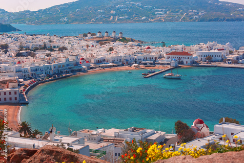 Foto Aerial view of Mykonos City, Chora with Old Port, white houses, windmilles and c