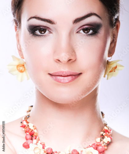 Portrait of young beautiful brunette woman in beads