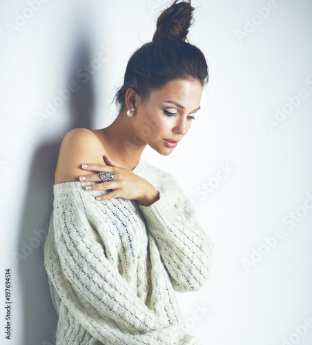 Portrait of a cute woman in sweater at home