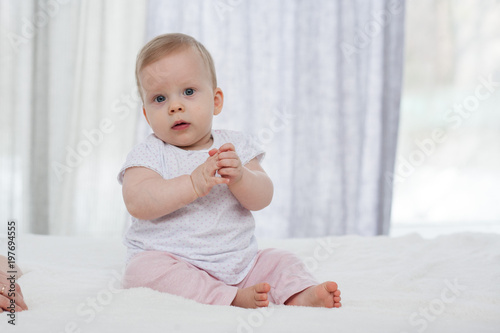 little chubby babe sitting in bed