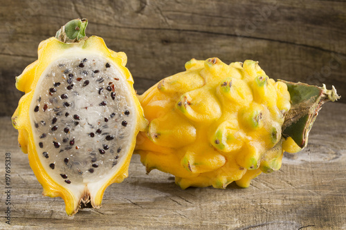 Yellow dragon fruit or dragon fruit on wooden background - Selenicereus megalanthus