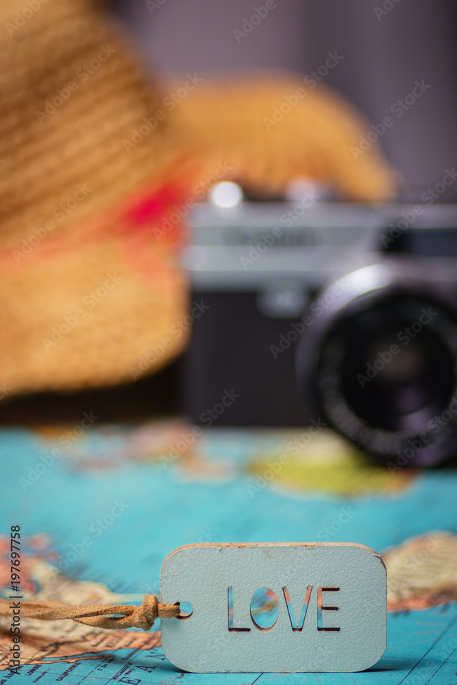 Obraz premium Travel concept background .A love sing on a map with a retro camera and a hat on the background