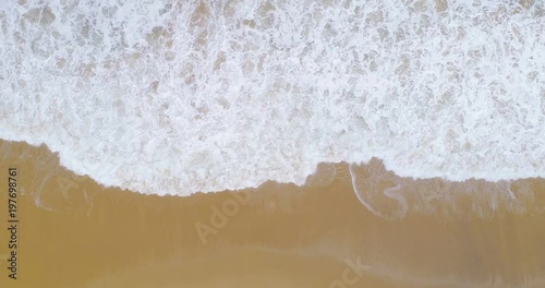 Quick time lapse of waves crashing onto the beach top down view aerial 4K