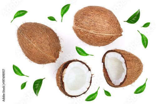 whole coconut with half decorated with leaves isolated on white background. Flat lay. Top view