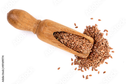 flax seeds in wooden scoop isolated on white background. Top view