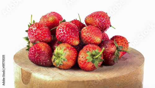 fresh strawberries on wood and white background
