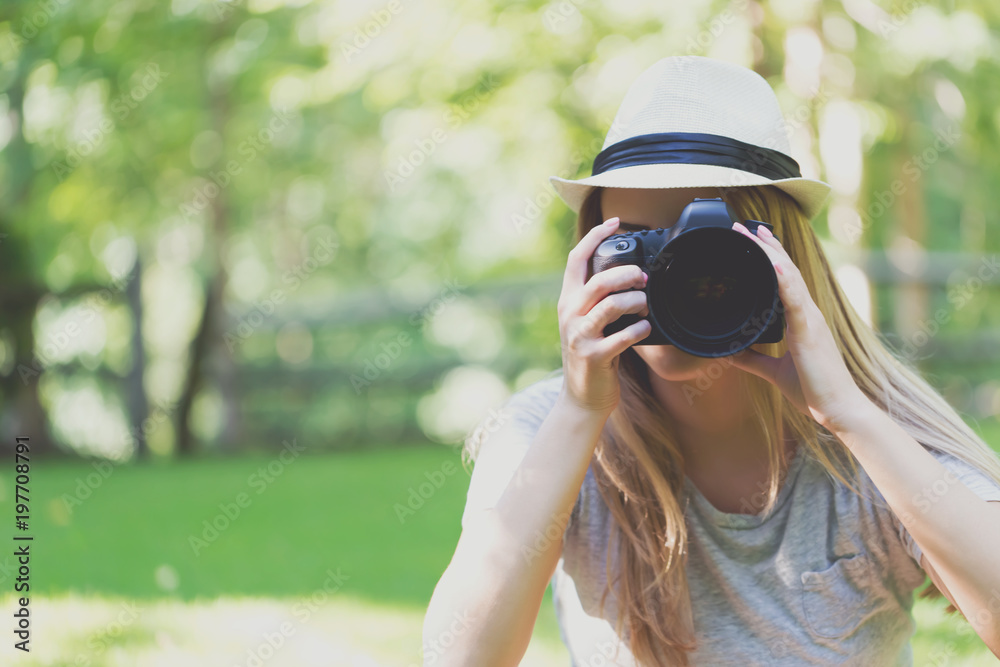 Female photographer with a DSLR camera outside Female photographer with a DSLR camera outside