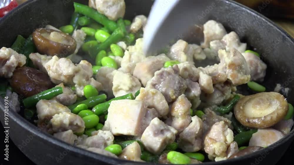 Stirring chicken shiitake in a pan Stirring chicken shiitake in a pan