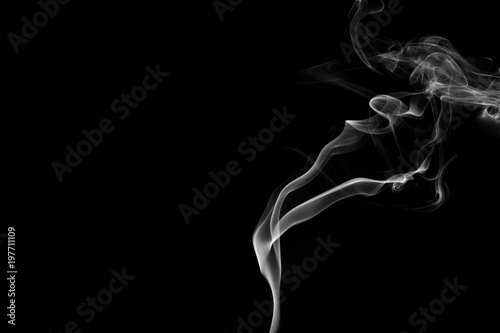 Fototapeta Naklejka Na Ścianę i Meble -  Smoke the white incense on a black background. darkness concept