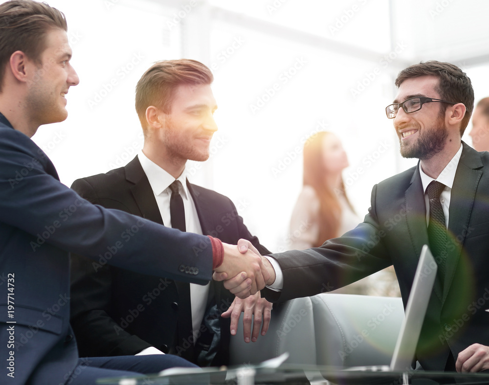 Partners concluding deal and shaking hands in the presence of te Partners concluding deal and shaking hands in the presence of te
