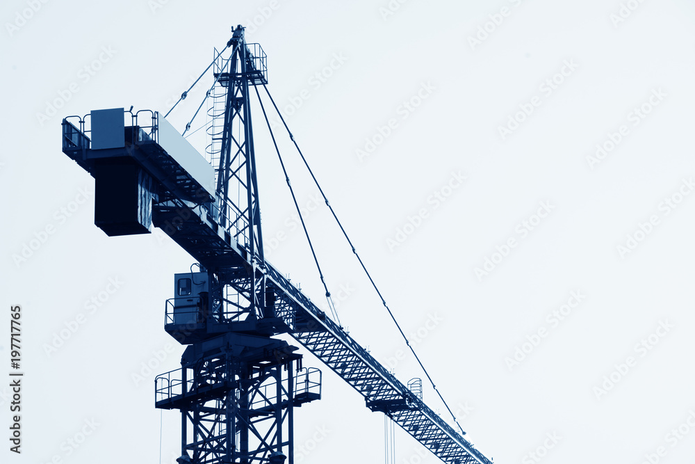 Abstract Industrial background with construction cranes silhouettes over amazing sunset sky