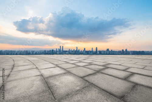 empty concrete floor and modern buildings in midtown of singapore in blue cloud sky