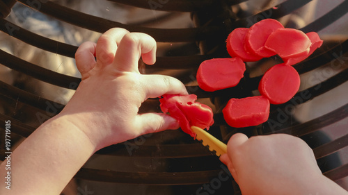 baby hands cutting plasticine - fine motor skill develop dexterity - pov above view