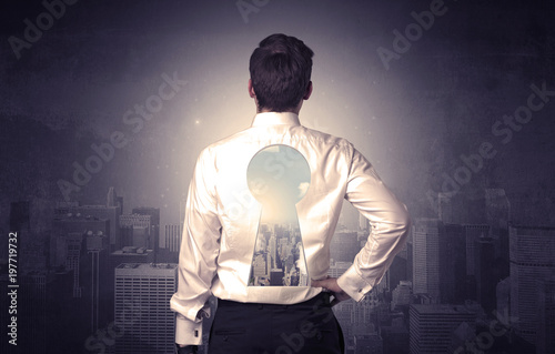 Businessman standing with keyhole on his back
