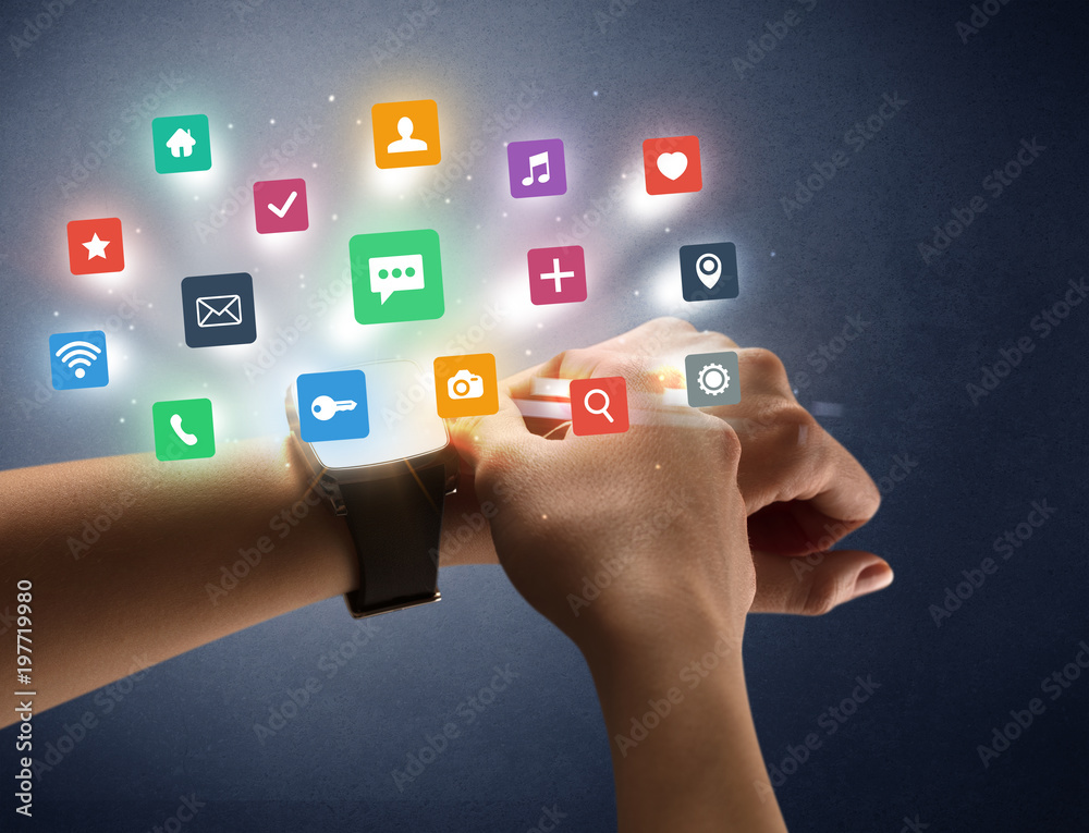 Female hand wearing smartwatch with app icons Female hand wearing smartwatch with app icons