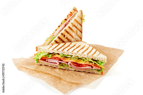 Sandwich with ham, cheese, tomatoes, lettuce, and toasted bread. Above view isolated on white background.