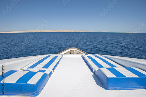 View over the bow over a large luxury motor yacht