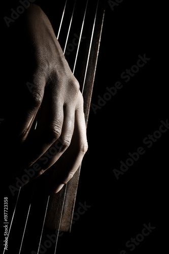 Cello strings. Cellist hands playing violoncello pizzicato