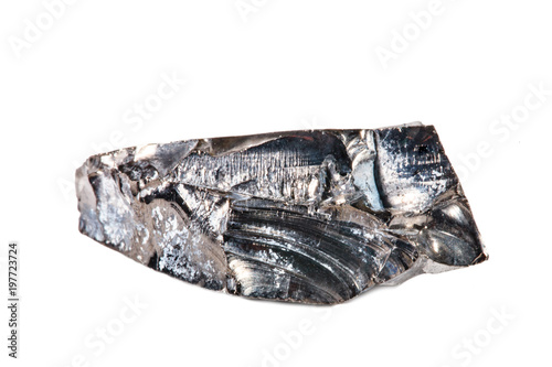 Macro shooting of natural gemstone. Raw mineral shungite. Isolated object on a white background.