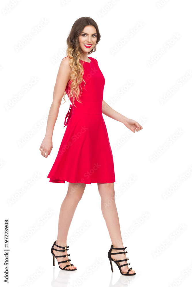 Walking Woman In Red Dress And High Heels Is Smiling